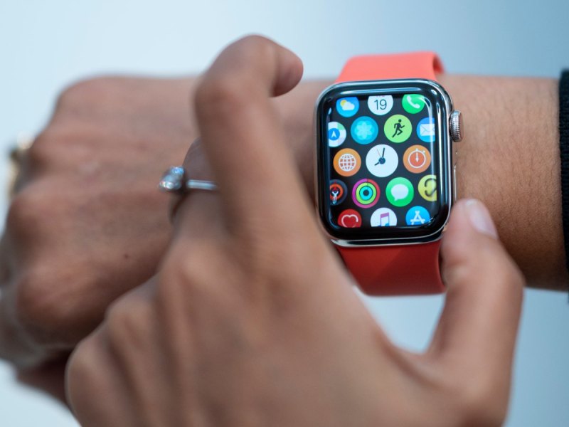 Person drückt einen Knopf an der Apple Watch