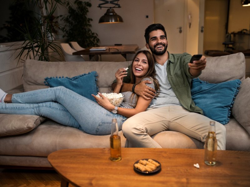 Paar guckt fernsehen auf dem Sofa