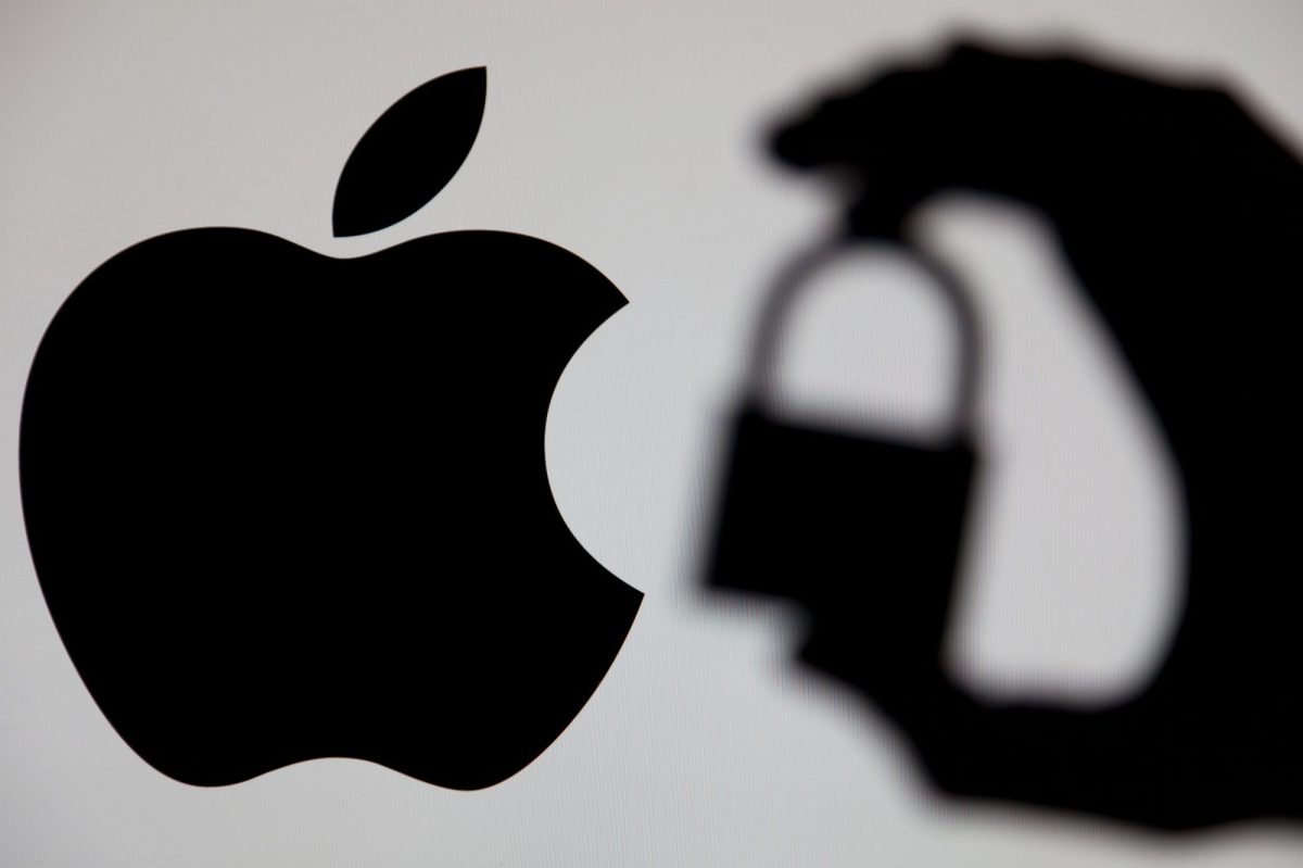 Apple-Logo vor einem weißen Hintergrund. Daneben ist der Schatten einer Hand zu sehen, die ein Sicherheitsschloss hält.