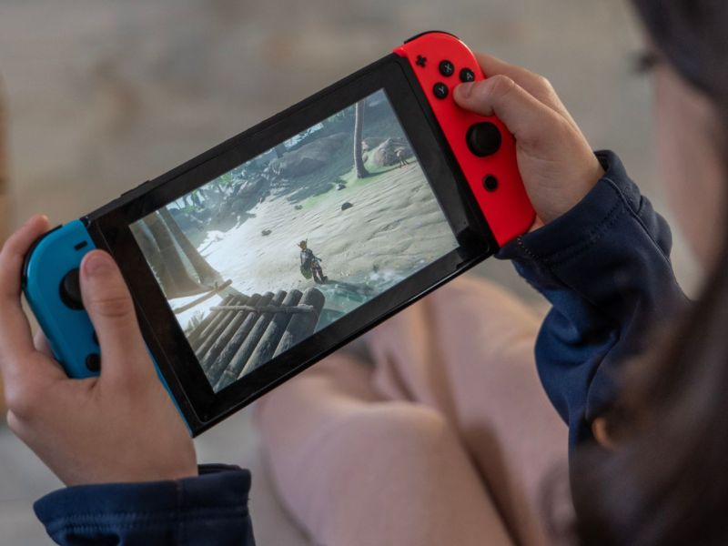 Person hält eine Nintendo Switch in den Händen.